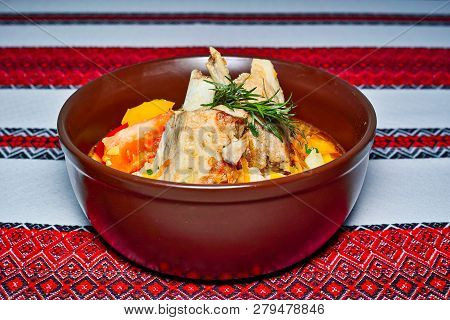 Plate With Stewed Lamb Ribs With Poizorami And Pepper, Decorated With A Sprig Of Greens.