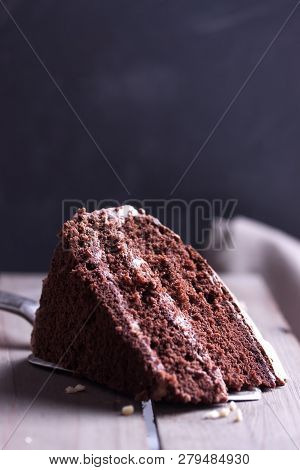 A Piece Of Chocolate Cake On Wooden Background