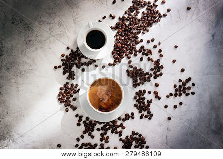 Cups Of Coffee With Coffee Beans, Sun Light On A Marble Background, Top View With Copy Space