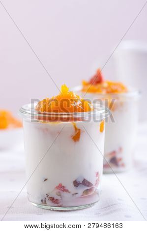 Dessert With Pumpkin Puree, Yogurt And Figs On White Background