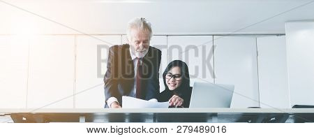Senior Businessman Coaches Work For Young Business Woman