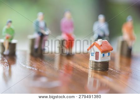 Mini House On Stack Of Coins,money And House,  Mortgage, Savings Money For Buy House And Loan To Bus