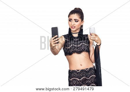 Young Gorgeous Girl Holds A Glass Of Champagne And Taking Selfie. Isolated On White