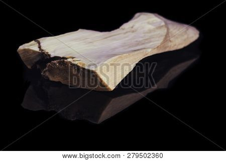 Piece Of Natural Petrified Wood With Opal On Black Background With Reflection