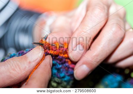 Needlework, Hands Of Old Woman Holding Knitting Needles And Multi Colored Wool For Woolwork Of Warm 