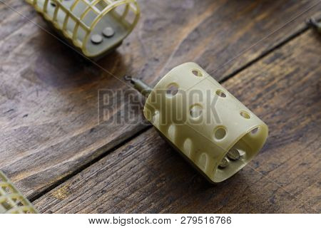 Necessary Accessories For Feeder Fishing On A Wooden Board. Feeder Feeders Side View.