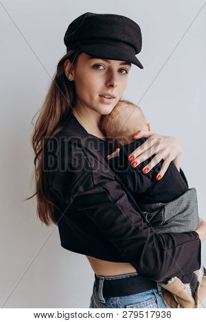 Pretty Woman Holding A Newborn Baby In Her Arms