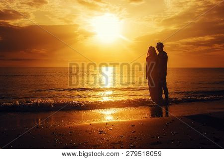 Lovers On The Sea Looking At The Sunset. Selective Focus