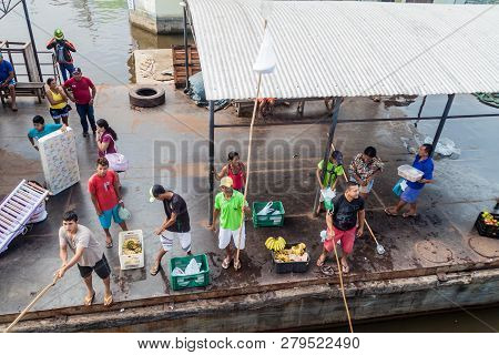 Juruti, Brazil - June 28, 2015: Sellers Use A Long Stick To Deliver The Goods To Passengers Of A Riv