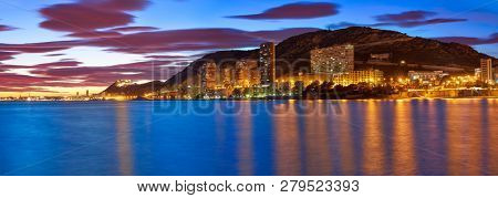 Alicante skyline at sunset from Albufereta beach in Spain Costa Blanca