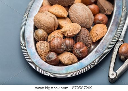 Different Kinds Of Nuts In The Shell: Hazelnut, Walnut, Almond And Brazil Nuts On The Plate With Nut