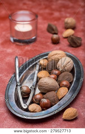 Different Kinds Of Nuts In The Shell: Hazelnut, Walnut, Almond And Brazil Nuts On The Plate With Nut