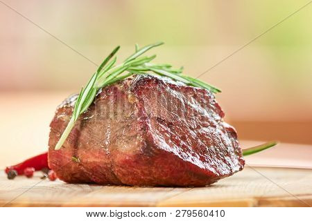 Pice Of Roasted Beef On Table Closeup. Roasted Beef And Side Dish.