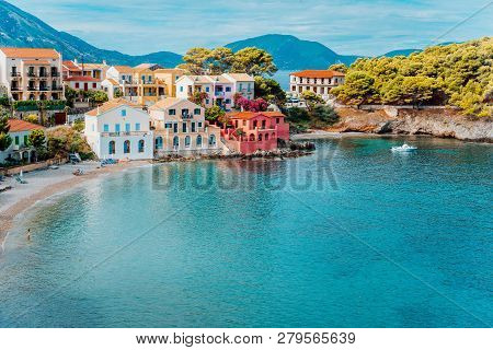 Assos Village. Beautiful View To Vivid Colorful Houses Near Blue Turquoise Colored Transparent Bay L