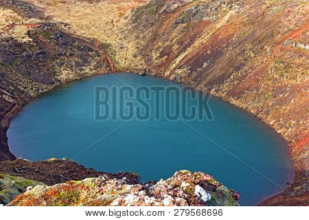 Tourists Visit A Volcanic Crater Lake In Iceland. The Lake Located In South Iceland, In Grimsnes Alo