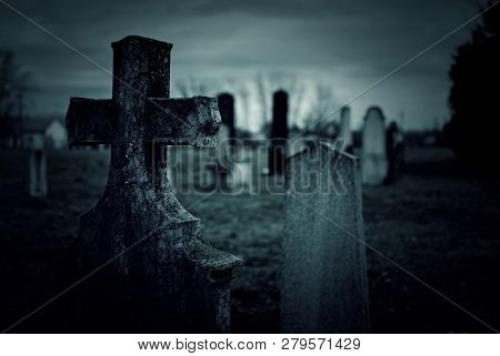 Tombstone On A Creepy Graveyard At Night