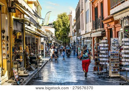 Athens, Greece - September 22 2018: Tourists Walk The Streets Lined With Souvenir Shops And Outdoor 