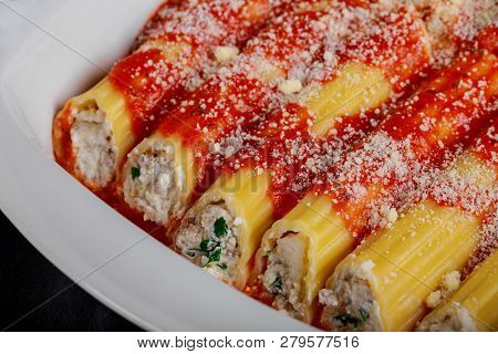 Many Manicotti And Tomato Sauce On A White Dish Plate