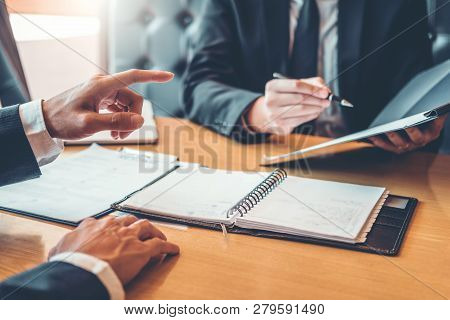 Senior Manager Reading A Resume During A Job Interview Employee Young Man Meeting Applicant And Recr