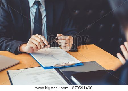 Senior Manager Reading A Resume During A Job Interview Employee Young Man Meeting Applicant And Recr