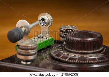 Detail Of An Old Crystal Radio Receiver Standing On A Wooden Table