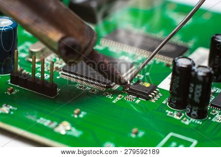 Close Up Of Microelectronics Engineering. Soldering Lead Repairing Computer Board Technology Concept