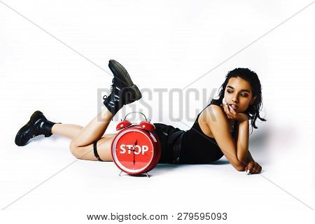 Young Pretty Indian Girl With Red Alarm Clock Posing Cheerful On White Background Isolated, Sexy Mod