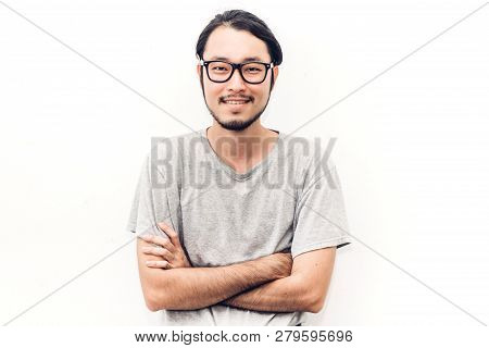 Portrait Of A Asian Young Handsome Man While Standing Isiolated On White Background