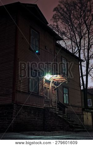 A Lonely Night Lamp Shares A Little Light Over The Stairs Of An Old Building In Tallinn, Estonia. Th