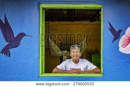 La Entrada, Ecuador - September 14, 2018 - Woman Looks Out Window In The Middle Of A Mural