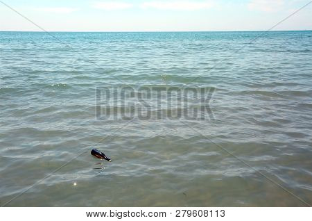 Bottle With Secret Message On The Ocean Without People In Summer Day