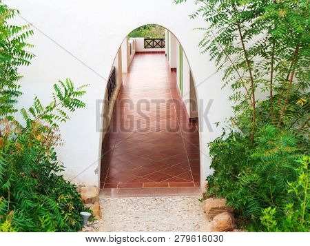 Archway Passage With Some Greenery To The Rooms At The Resort