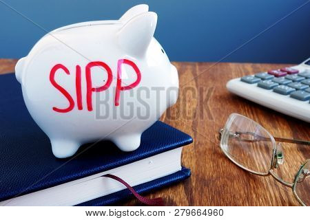 Sipp Self Invested Personal Pension Written On A Piggy Bank.