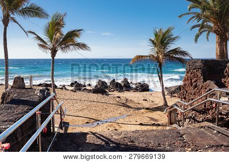 Puerto Del Carmen Beach In Lanzarote, Canary Islands, Spain. Blue Sea, Palm Trees, Selective Focus