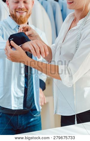 Man in fitting of a bespoke shirt in fashion studio of tailor