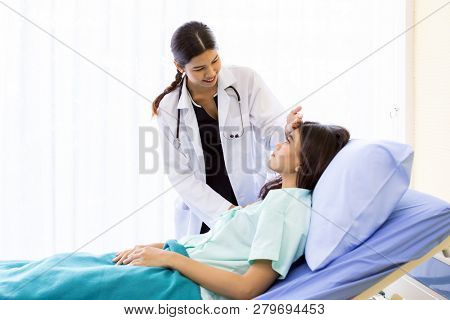 Asian Doctor make routine health check with patient in hospital ward