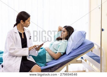 Patient fell worry when Asian Doctor make routine health check in hospital ward