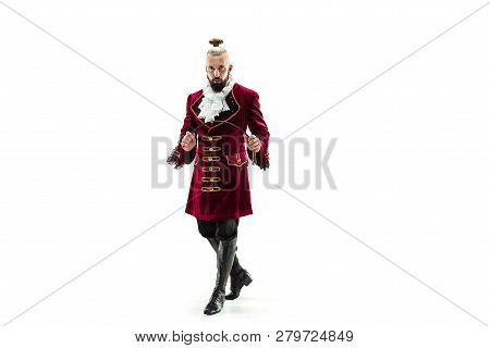 The Young Man Wearing A Traditional Medieval Costume Of Marquis Posing At Studio With Whip. Fantasy,