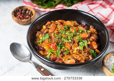 Chili Con Carne From Meat, Beans And Vegetables In Black Plate On Stone Table. Traditional Mexican F