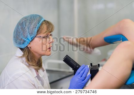 Professional Gynecologist Examining Her Female Patient On A Gynecological Chair.