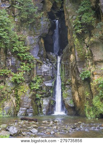 Salto Do Cabrito Beautiful Waterfall At Hiking Trail Falling A From Rock Cave In Green Forest, Sao M