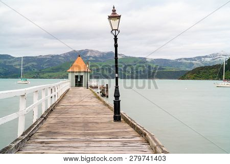 Akaroa Jetty With Shed And Orange Round Conical Roof At End