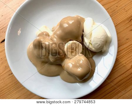 Profiteroles With Tahin / Tahini Sauce And Banana Slice Served At Restaurant.