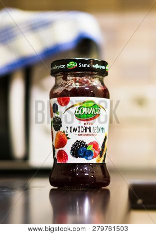 Poznan, Poland - November 20, 2018: Polish Lowicz Forest Fruit Jam In A Glass Jar On A Wooden Table.