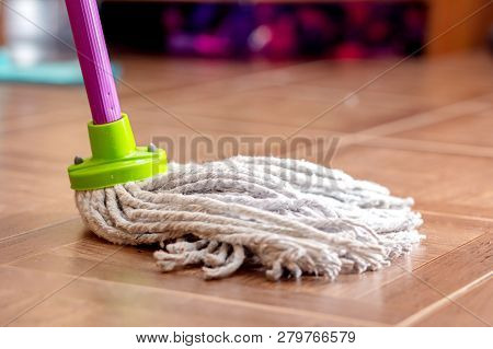 Rope Mop For Cleaning The Floor Is On The Floor Of The Tile.