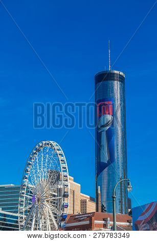 Ferris Wheel In Atlantaa Centennial Park With Peachtree Plaza Hotel In The Background Displaying The