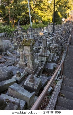 Kumamoto, Japan - November 13, 2018: Broken stone lanterns beside the stairs of the Honmyo-ji Temple after the earth quake in 2016 