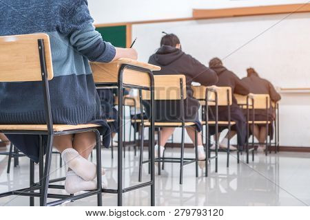 Behind Group Of Asian High School, University Student Having Test Exams For Taking Writing Examinati