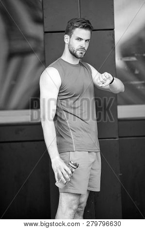 Sporty Regime. Man Athlete Check Time Hold Bottle Care Hydration Body After Workout. Drink Regime Wa