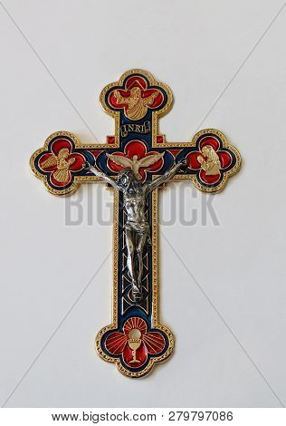 Red Blue And Gold Metal Crucifix With Silver Body Of Jesus Christ And Images Of Father Holy Spirit A